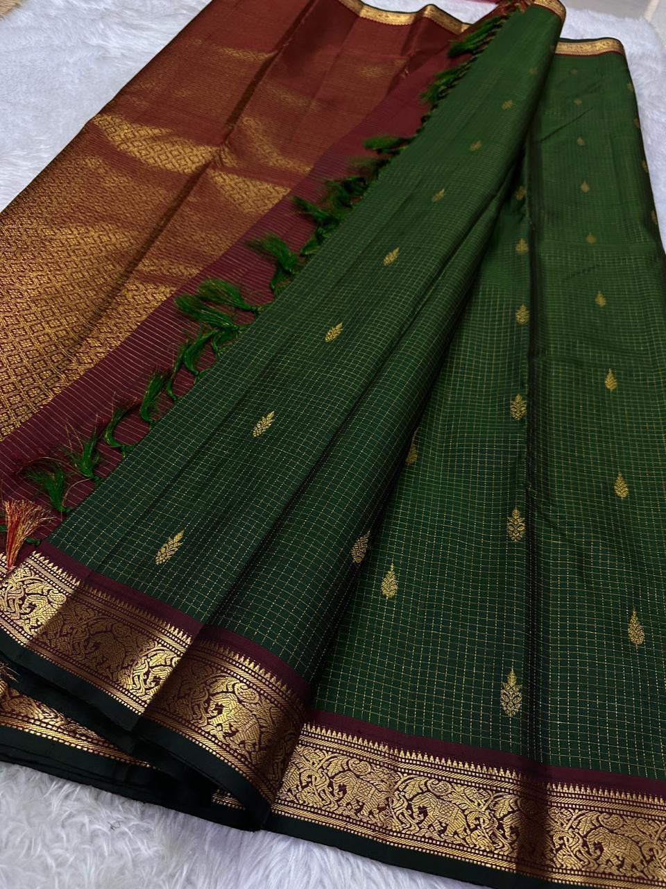 Pure Kanchipuram Silk Saree laid out with deep green zari kattam checks, gold motifs, and maroon zari woven border, available in the USA