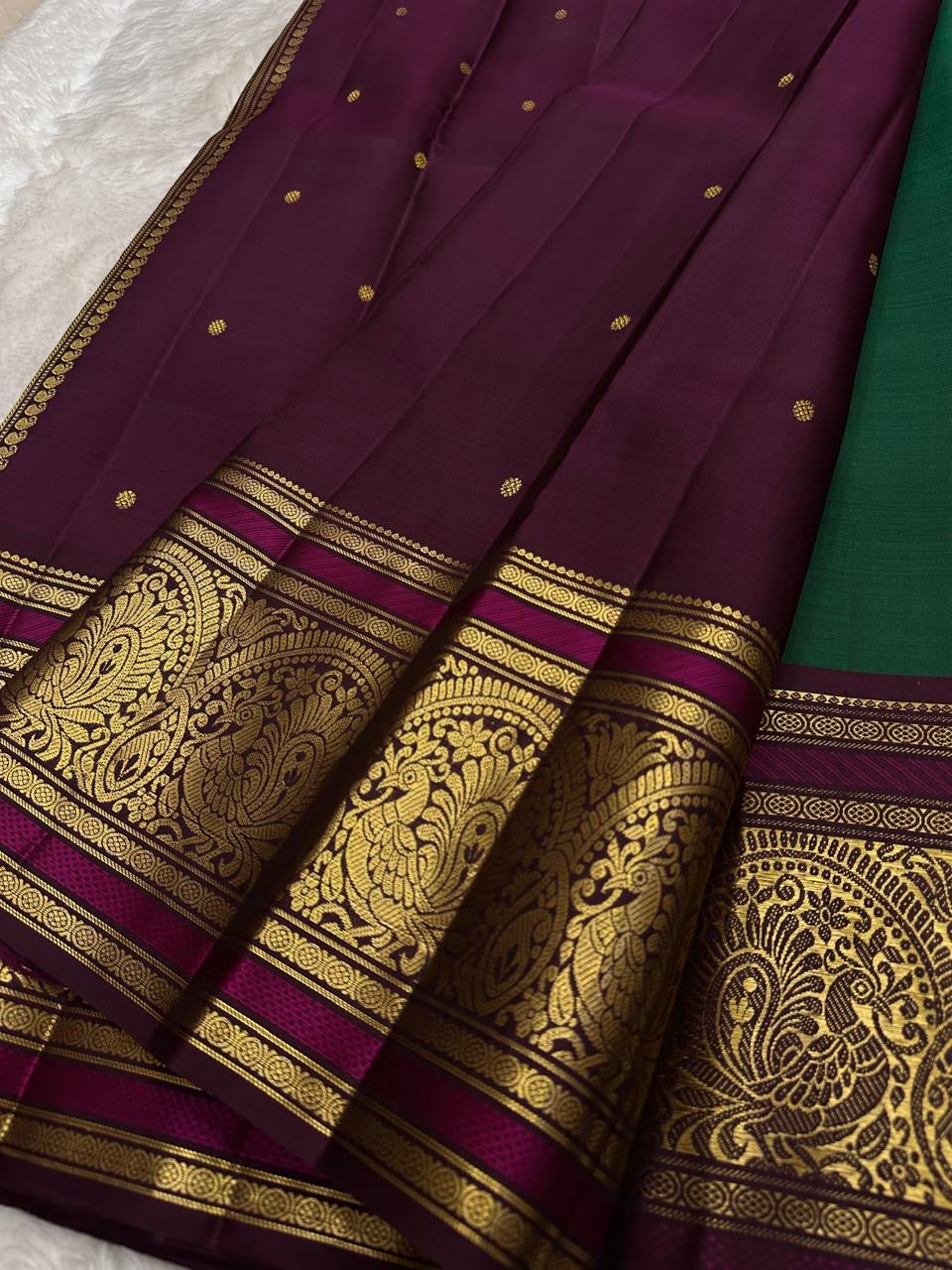 Green Kanchipuram silk saree with sorgavaasal mayil peacock motif detail