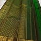Kanchipuram border with repeated gold zari Yaanai elephant motifs and warm rust-red silk edge.