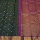 Handwoven green Kanjivaram saree with gold zari buttas and double side pet border