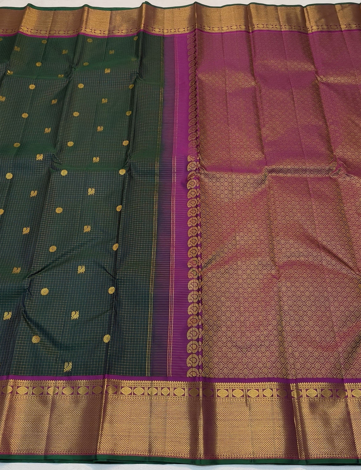Handwoven green Kanjivaram saree with gold zari buttas and double side pet border