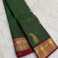 Detail of the saree border: An Arakku red and gold border with a repeated Yaanai register above a closely worked geometric zari base.