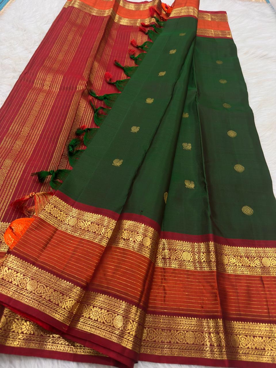 Deep Green handwoven Pure Silk Kanchipuram saree showing the full body and contrast zari border.