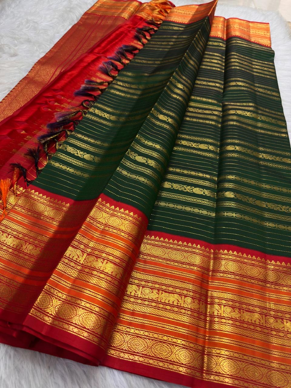 Close view of the green silk body with visible handwoven zari details and traditional border.