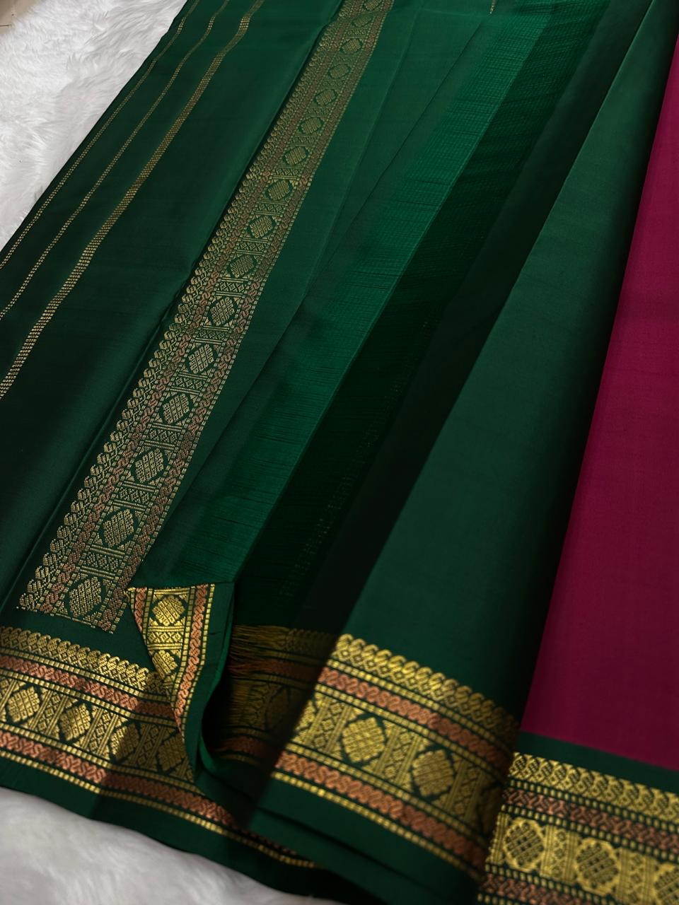 Pure Kanchipuram silk saree spread view showing green and deep pink sections with gold zari border, available in the USA