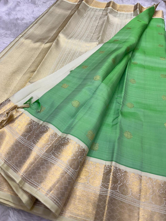 Fresh green korvai Kanjivaram silk saree with muted antique gold zari and heritage ivory border