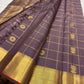 Handwoven Zari Kattam Kanjivaram saree with fine gold checks and meenakari medallion motifs.