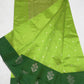 Close-up of the Deep Forest Green floral border on the Parrot Green Pattu Silk Chanderi saree