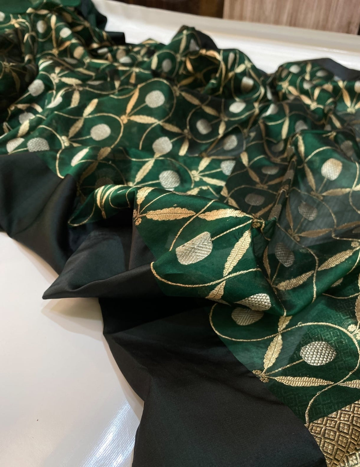 Gold leaf motifs woven across deep green Pattu Silk Chanderi