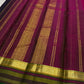 Gold zari buttas on deep black Kanchipuram silk.