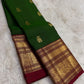 Deep green Kanchipuram silk with individually spaced gold-zari Yaanai Ambari elephant buttas.