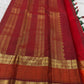 Full drape view highlighting the green body, contrast border and traditional zari workmanship.