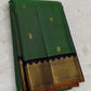 Close view of Maragatham green silk body woven with fine gold oosi lines and small individually spaced zari buttas.