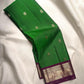 Close view of Ilai Pachai Green Kanchipuram silk with traditional gold zari buttas.