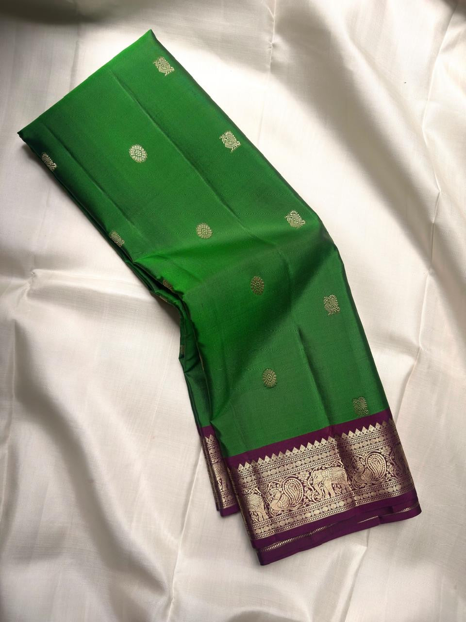 Close view of Ilai Pachai Green Kanchipuram silk with traditional gold zari buttas.