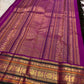Close view of Kalam paisley buttas on the green silk body of a Kanchipuram saree