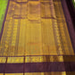 Full view green Pure Kanchipuram silk saree with scattered gold woven motifs and wide purple zari woven elephant border