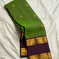Green Pure Kanchipuram silk saree folded with broad purple contrast border and gold zari woven elephant detailing