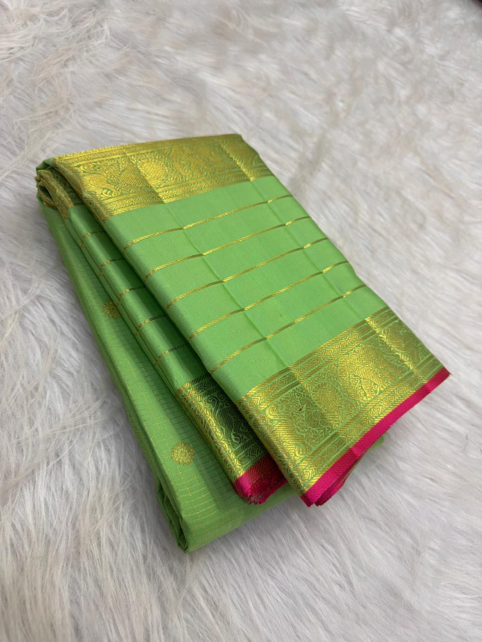 Green pure mulberry silk Varisaipet saree with fine gold zari lines and Rani Pink selvedge.