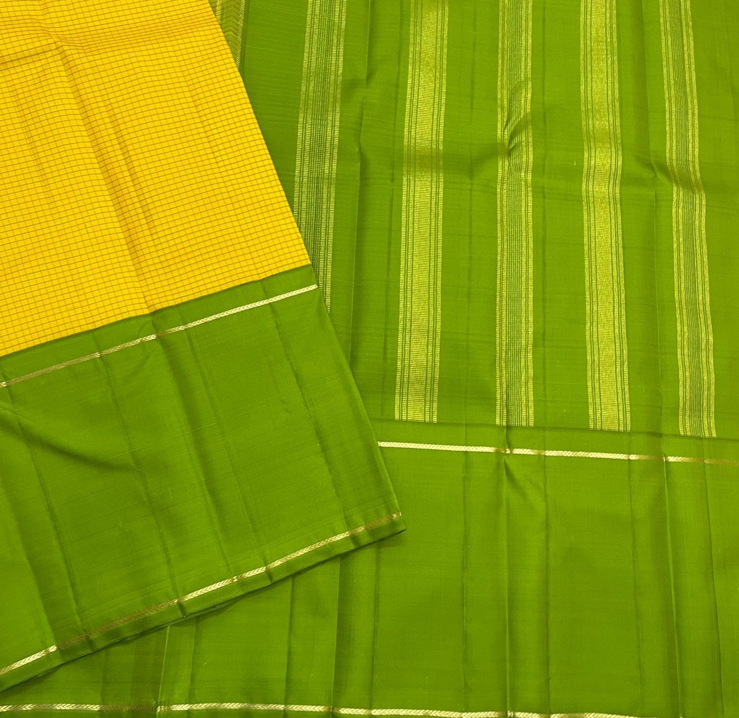 Green Pure Kanchipuram silk saree detail with yellow checked section and fine zari woven stripe accents