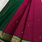 Pure Kanchipuram silk saree draped flat showing deep pink body with evenly spaced gold zari buttas and narrow zari border