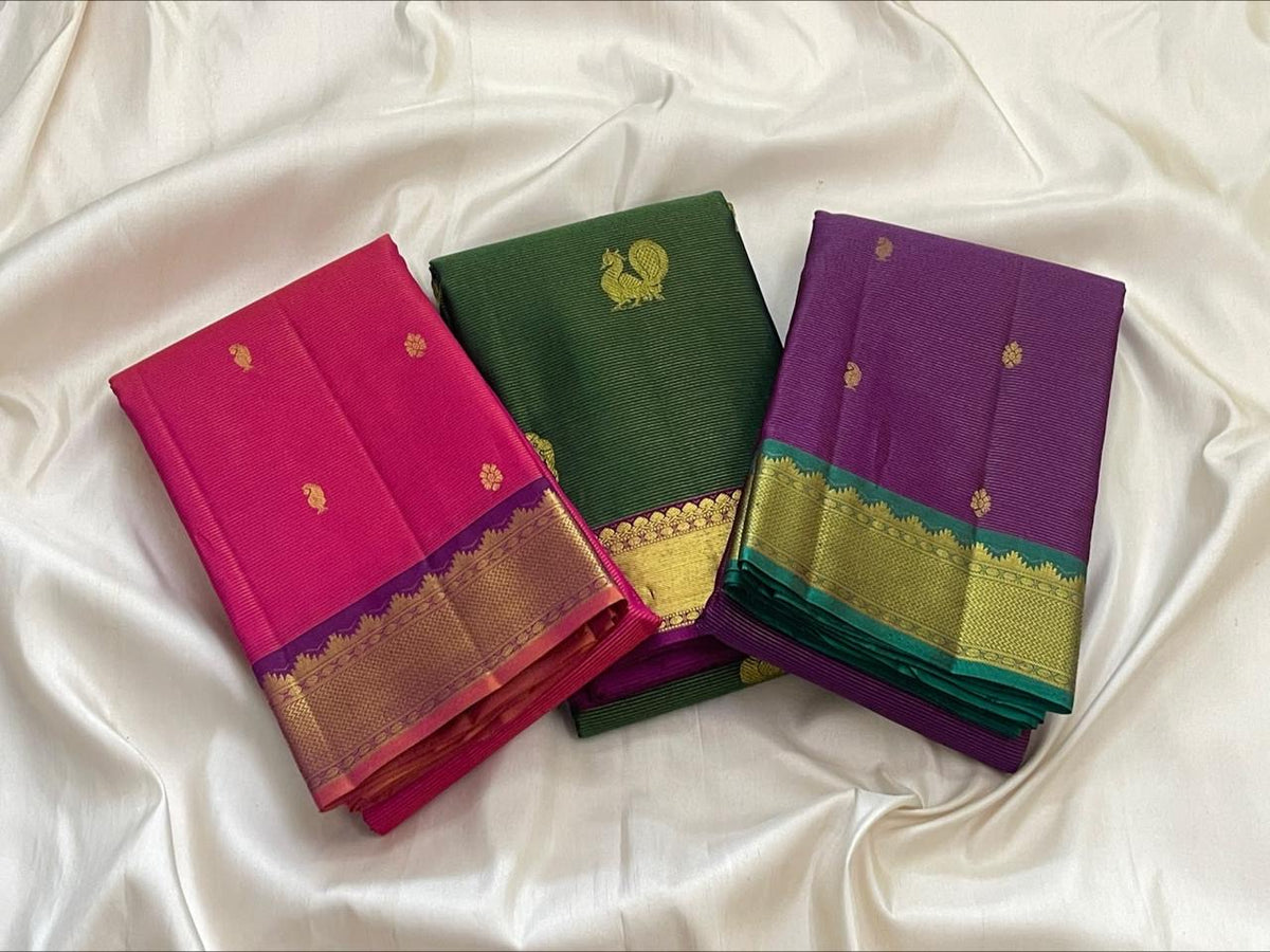 Close view of Vairaoosi lines and gold zari buttas on deep green silk