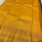 Close view of forest-green body paired with bright manjal yellow woven silk