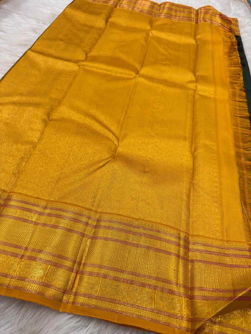 Close view of forest-green body paired with bright manjal yellow woven silk
