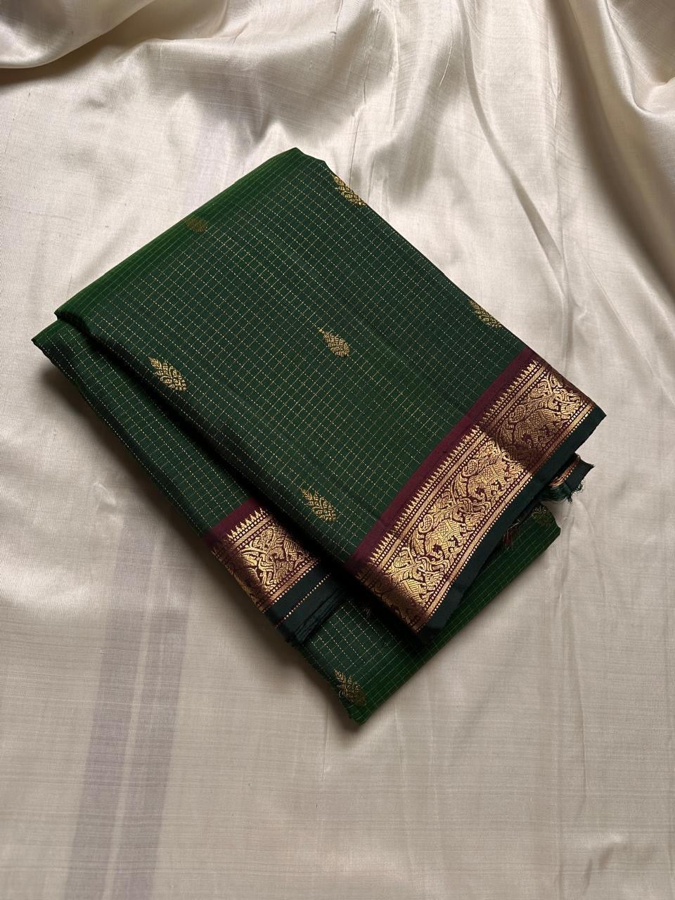Folded Pure Kanchipuram Silk Saree in deep green zari kattam checks with small gold motifs and maroon zari woven border