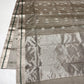 Stone Grey Katan Silk Chanderi saree detail with silver-tone motifs and small Emerald Green accents.