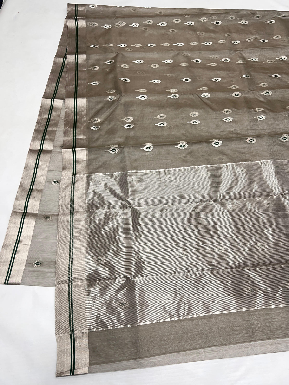 Stone Grey Katan Silk Chanderi saree detail with silver-tone motifs and small Emerald Green accents.