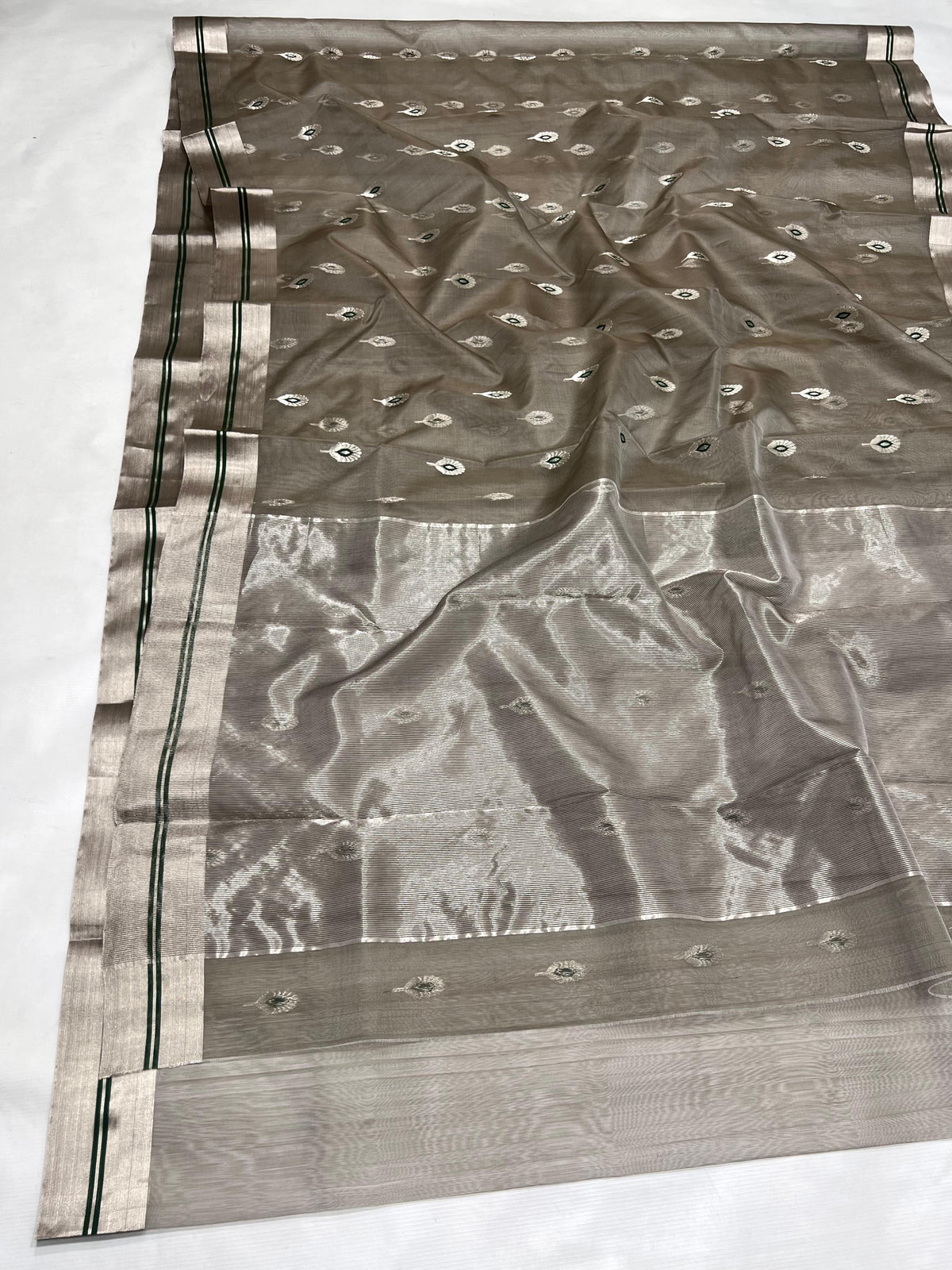 Draped Stone Grey Katan Silk Chanderi showing silver-tone motifs with green centres and silver border with green stripes.