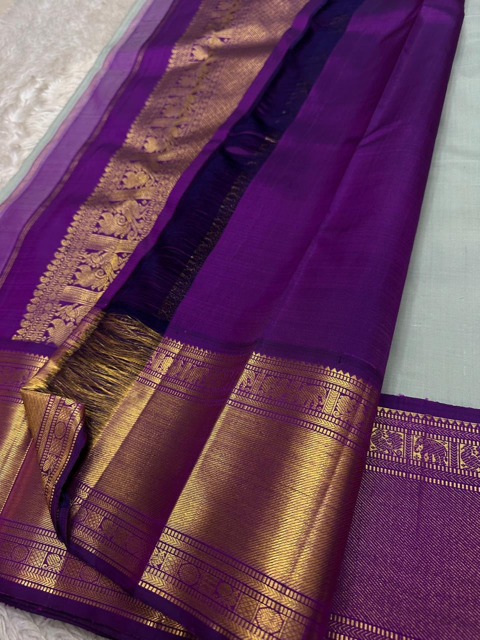 Close view of vibrant purple pallu with gold zari pattern and tassels, shipped from New Jersey USA