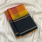 Turmeric yellow Kanchipuram silk saree, charcoal black pallu with fine red and metallic stripes
