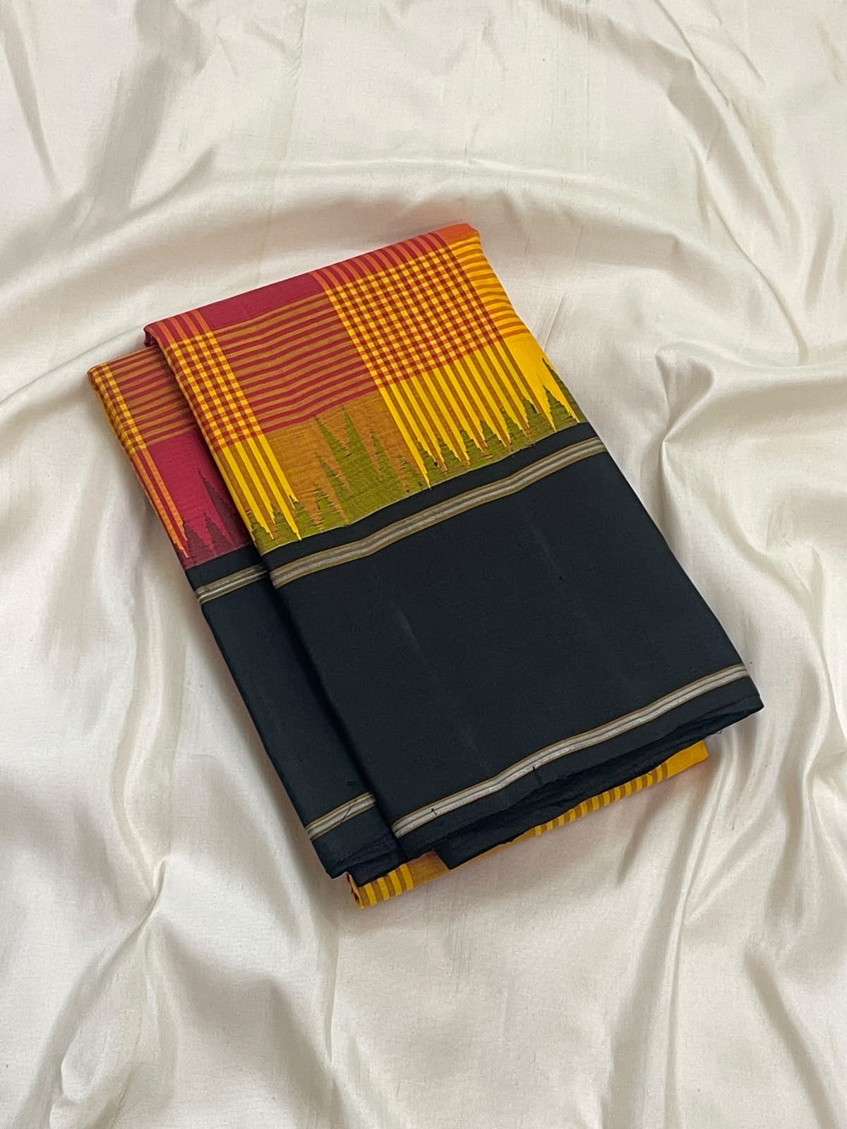 Turmeric yellow Kanchipuram silk saree, charcoal black pallu with fine red and metallic stripes