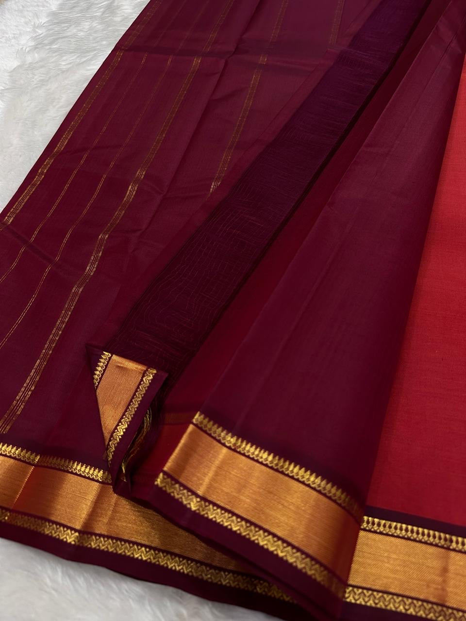 Brick Red and Deep Arakku Maroon lightweight Kanchipuram silk saree, broad gold zari border and striped maroon pallu; pallu detail