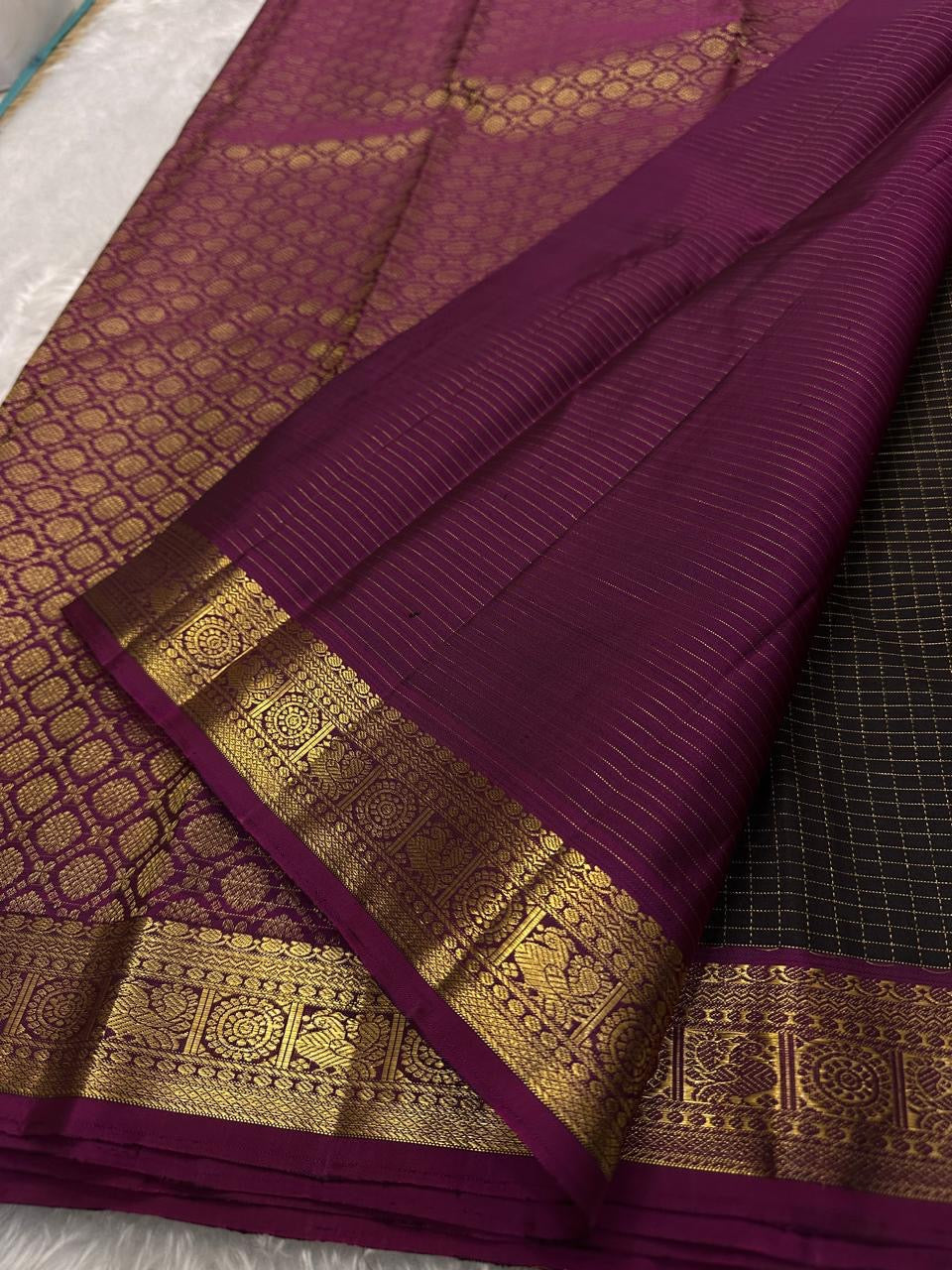 Close-up of magenta pallu with fine zari lines and gold zari border on pure Kanchipuram silk saree