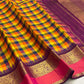 Pure Kanchipuram silk saree draped to highlight checked body and ornate gold zari border with pink accent