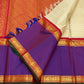 Pure Kanchipuram silk saree showing purple border panels with gold zari woven motifs and blue tassels