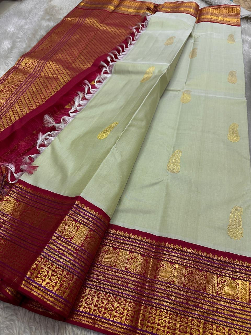 Sage green Pure Kanchipuram silk saree spread with maroon zari woven pallu and tassels, shipped from New Jersey USA