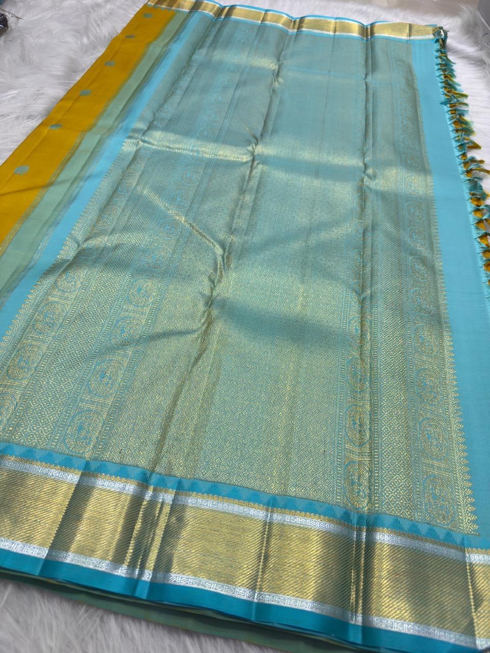 Silk thread Mayil and Yaanai buttas on Golden Turmeric Kancheepuram silk saree body