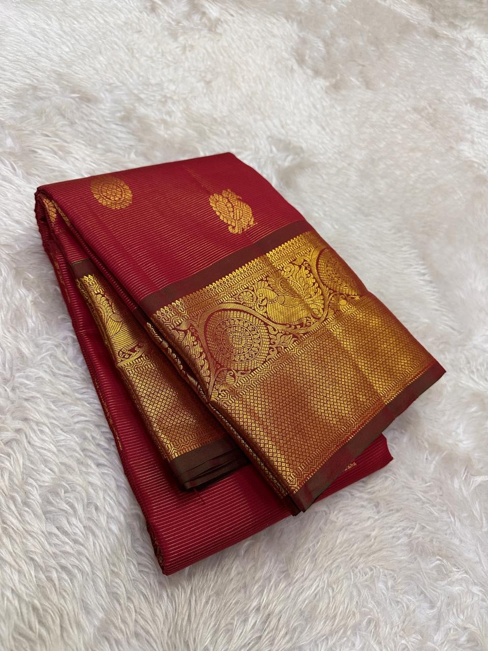 Handwoven Pure Silk Kanchipuram saree in bright vermilion red with a luminous petal pink pallu with petite Gandaberunda zari buttas.