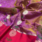 Close view of purple and pink Chanderi saree with oversized silver-toned floral motifs and green woven leaves