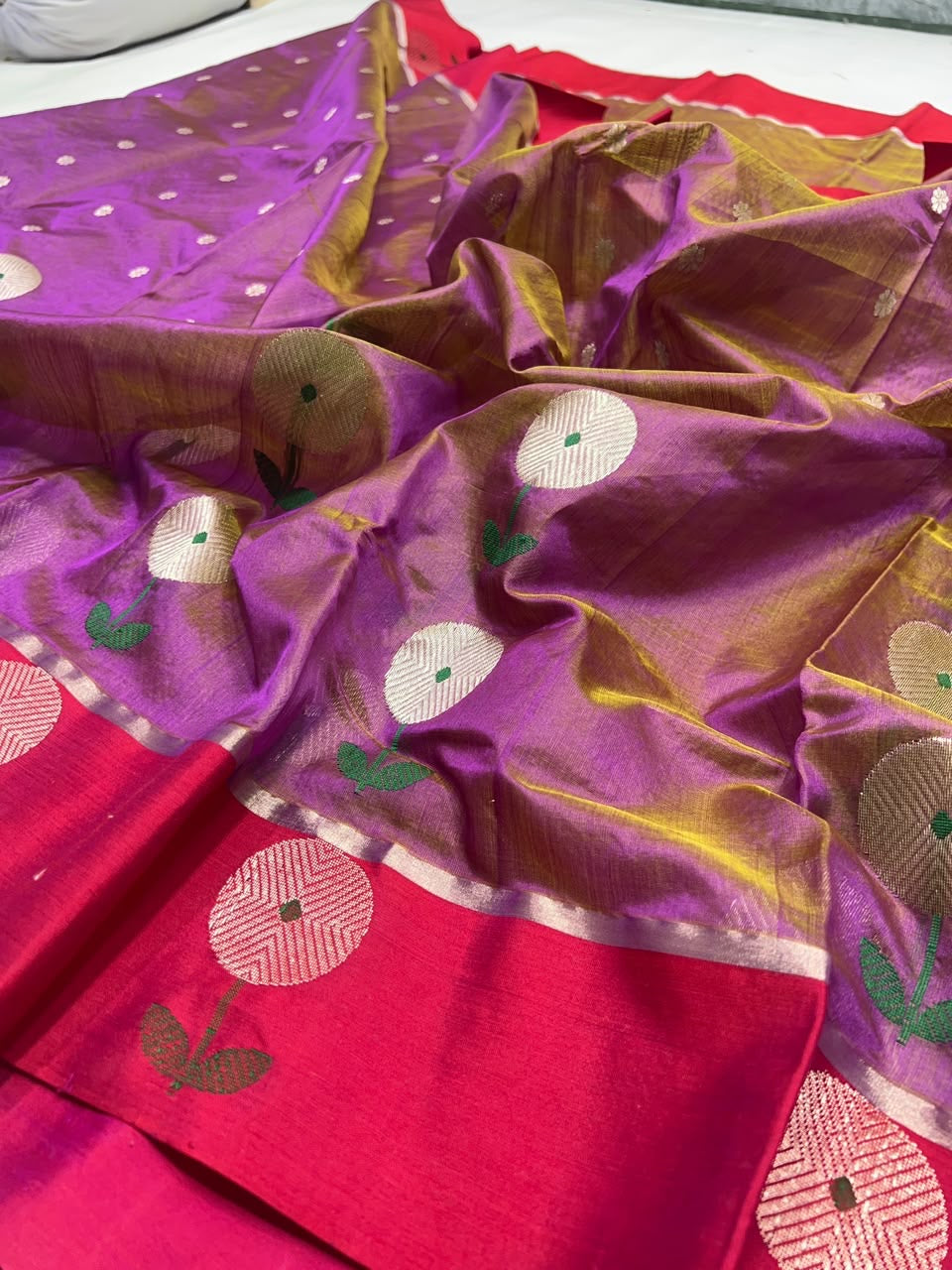 Close view of purple and pink Chanderi saree with oversized silver-toned floral motifs and green woven leaves
