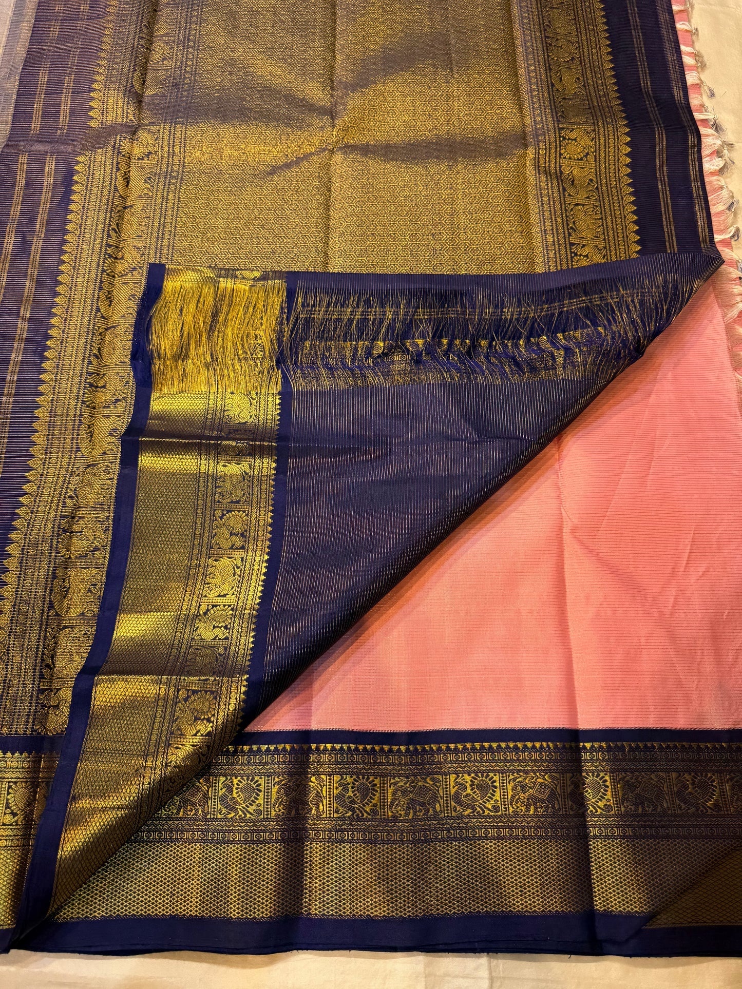Full view rose pink Kanchipuram silk saree with navy and antique gold zari woven borders, shipped from New Jersey USA