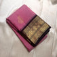 Folded pink Pure Kanchipuram Silk Saree with black zari border and gold paisley motifs, available in the USA