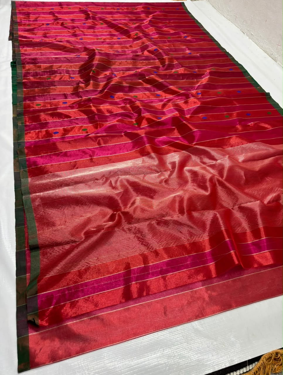 Handloom Tissue Silk Chanderi saree with multicolour cobalt-blue and green buttas on a Vermilion Red and Rani Pink ground