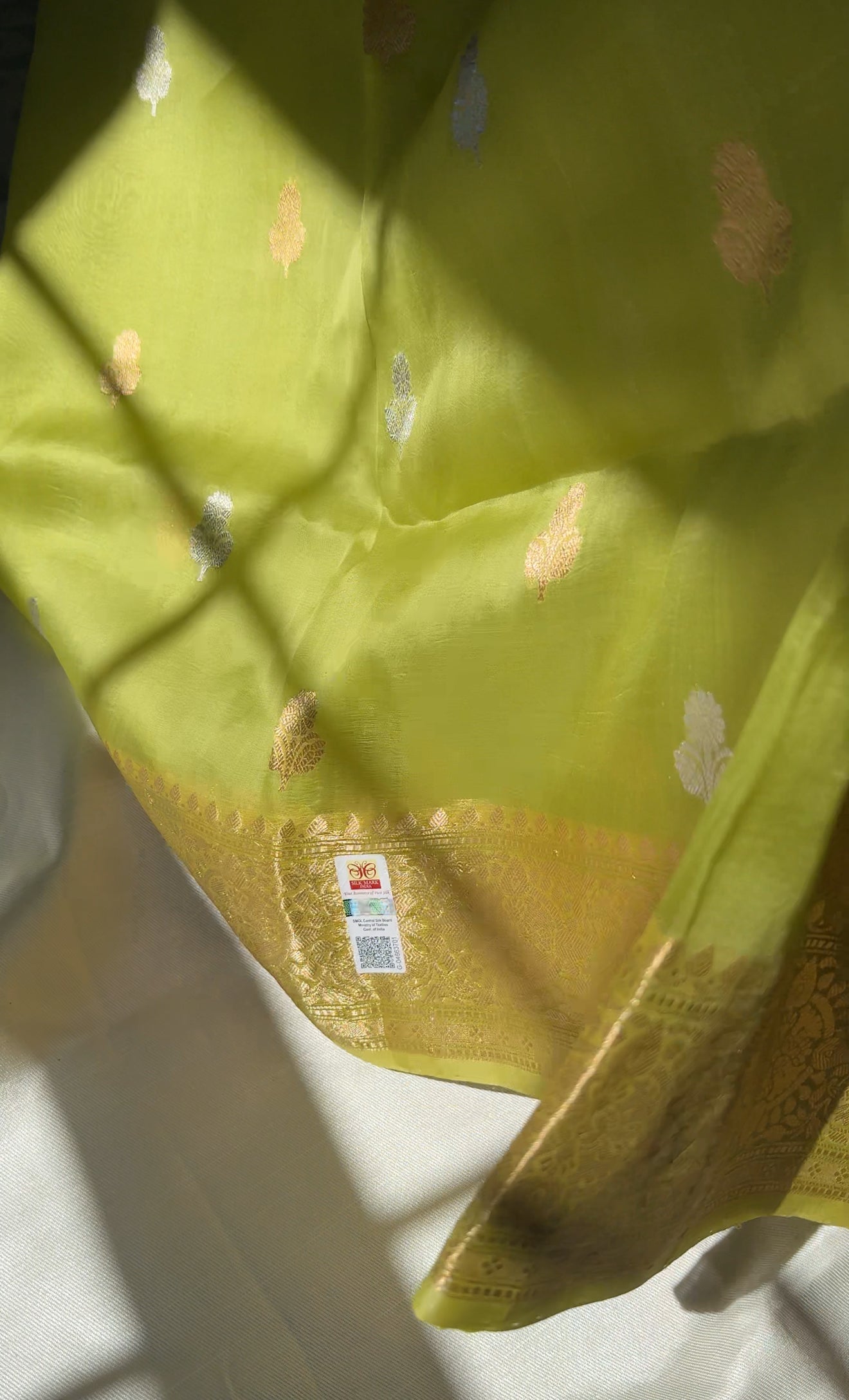 Full zari striped blouse fabric attached to chartreuse kora silk Banarasi saree with sona-roopa motifs