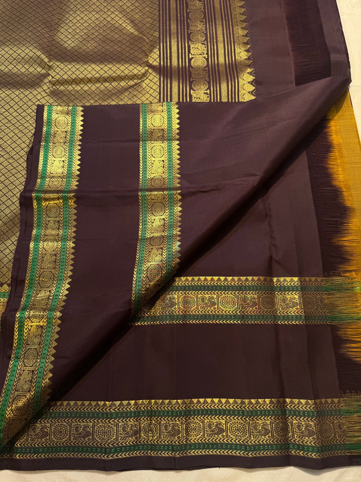 Circular gold medallions within the traditional border.