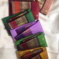 Golden Turmeric pure silk Kanchipuram saree, Butta weave with Deep Aubergine border — folded view